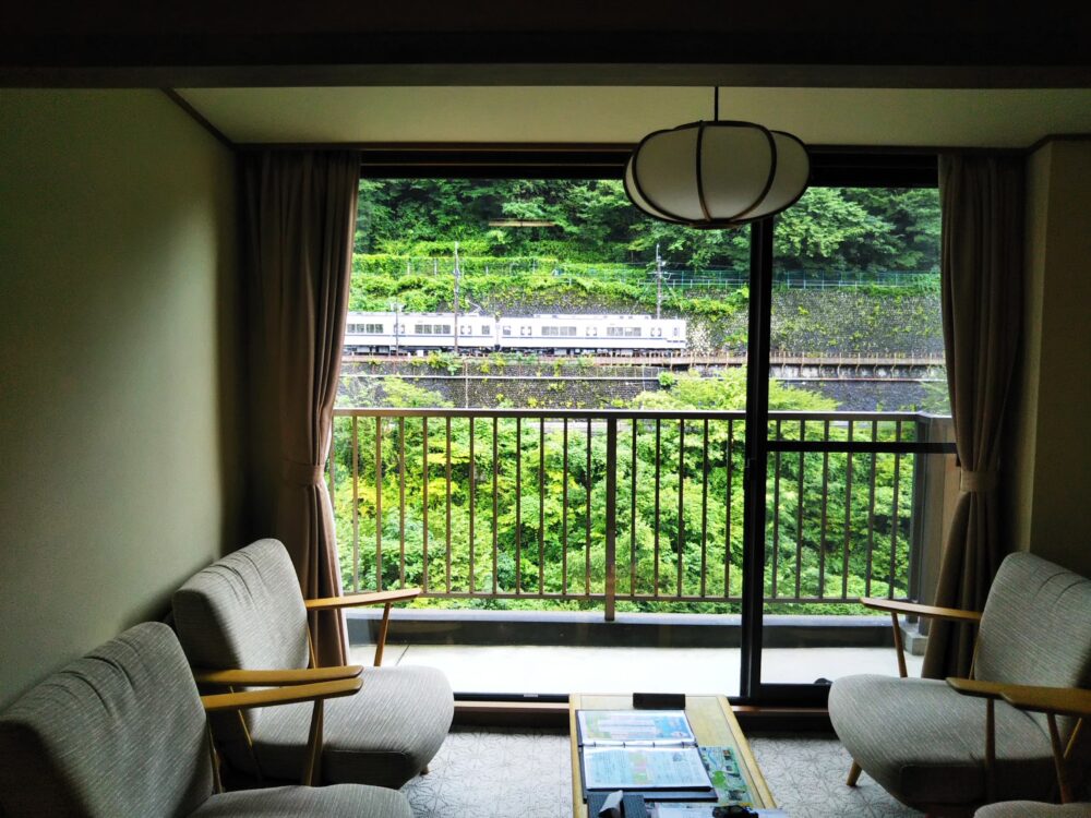 トレインビューホテル「鬼怒川温泉あさや」｜部屋から見える電車・通勤電車と椅子の様子